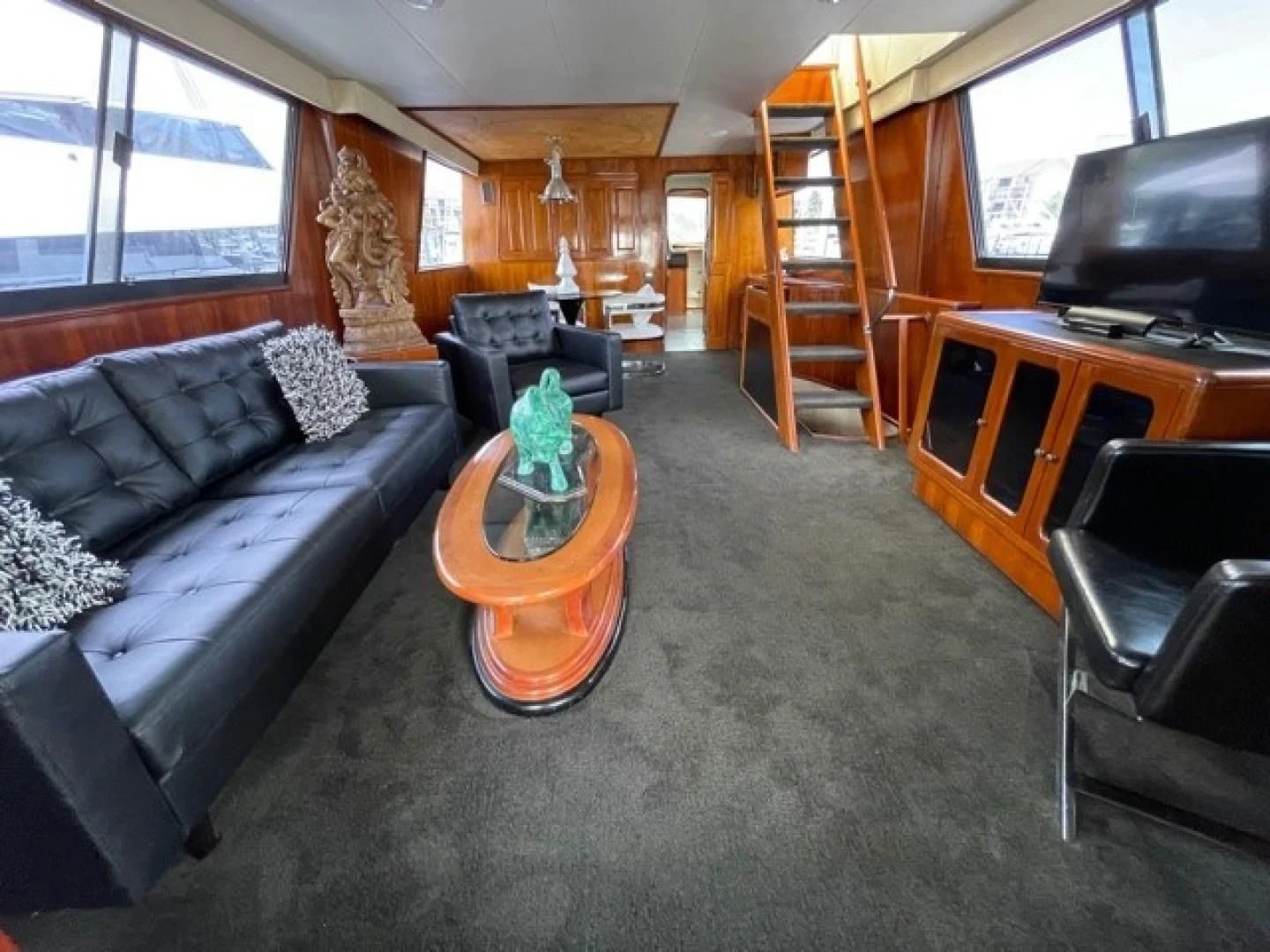 a living room with a couch and a tv aboard MR. ED Yacht for Sale