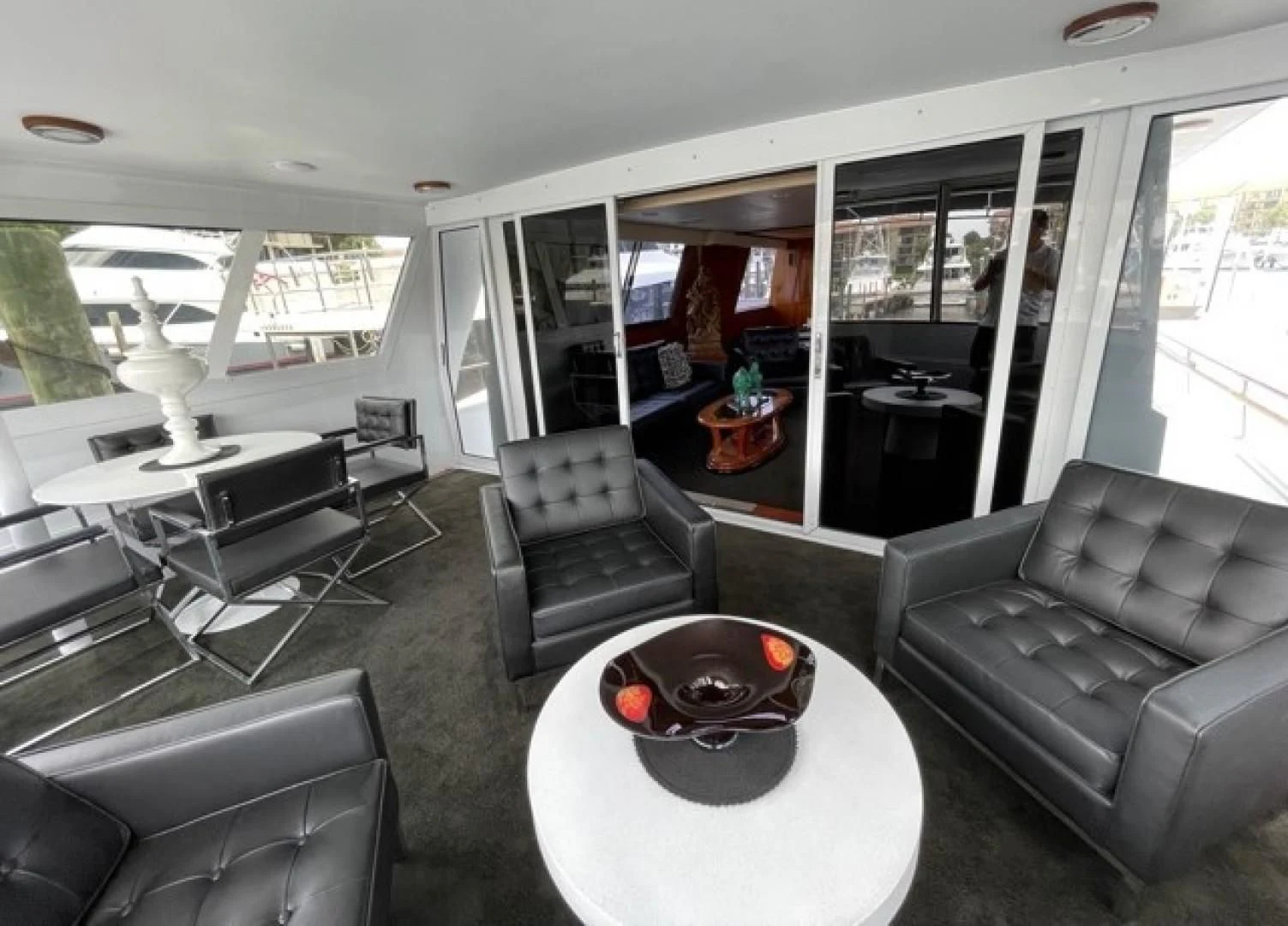 inside of a vehicle with a table and chairs and a couch aboard MR. ED Yacht for Sale