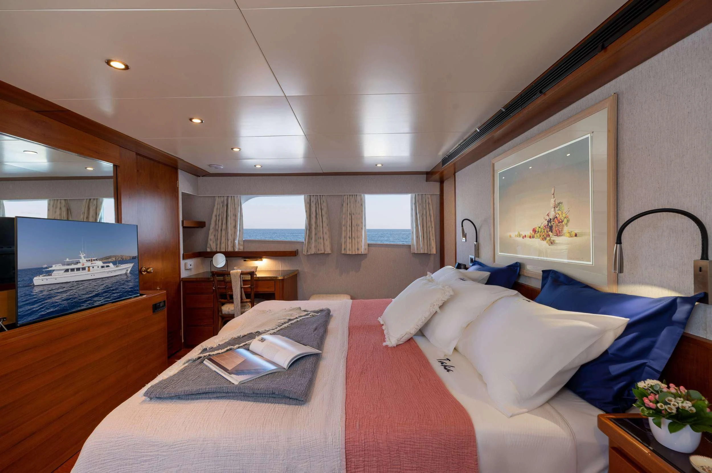 a bed with a laptop on it aboard TAKA Yacht for Sale