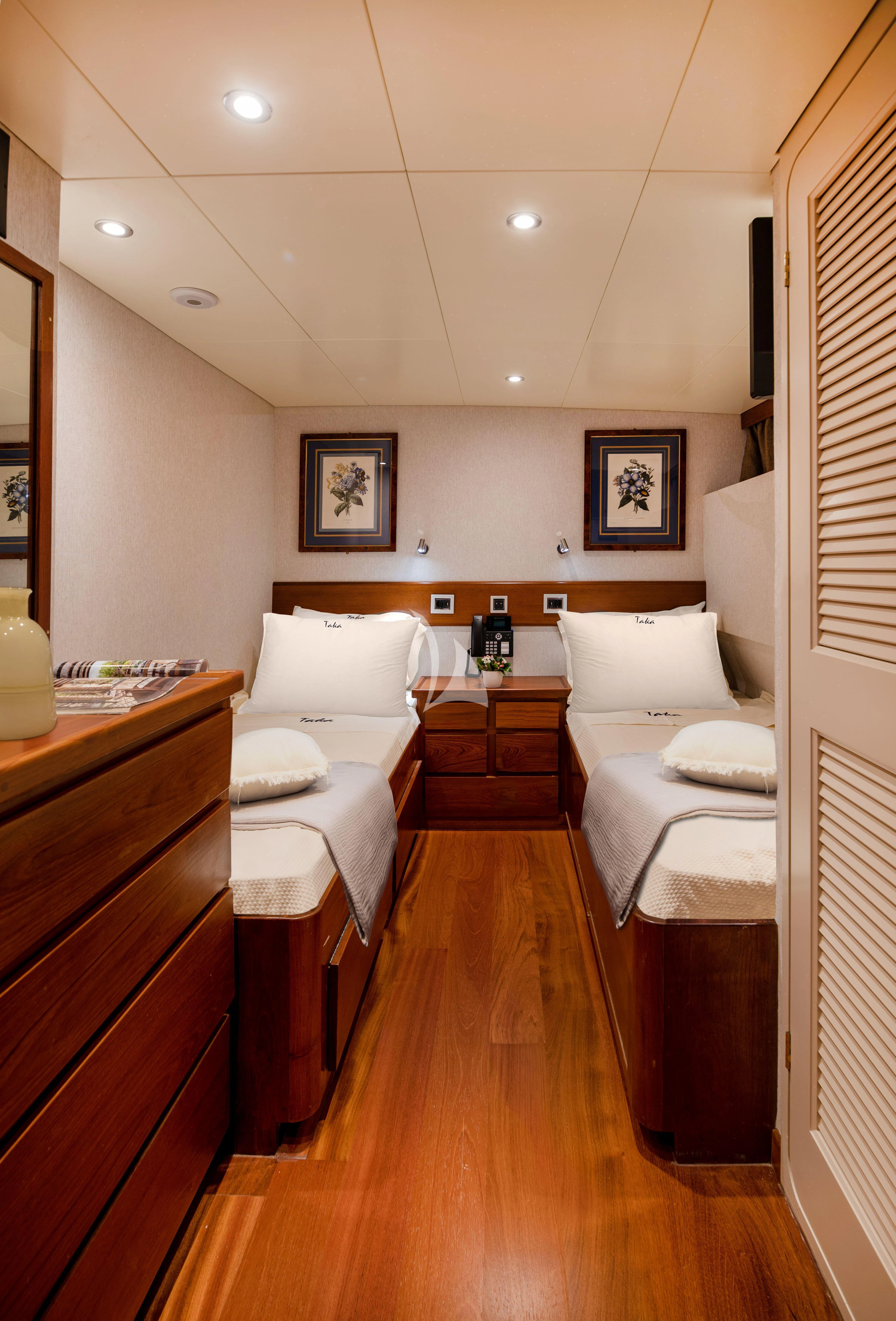 a room with a bed and a mirror aboard TAKA Yacht for Sale