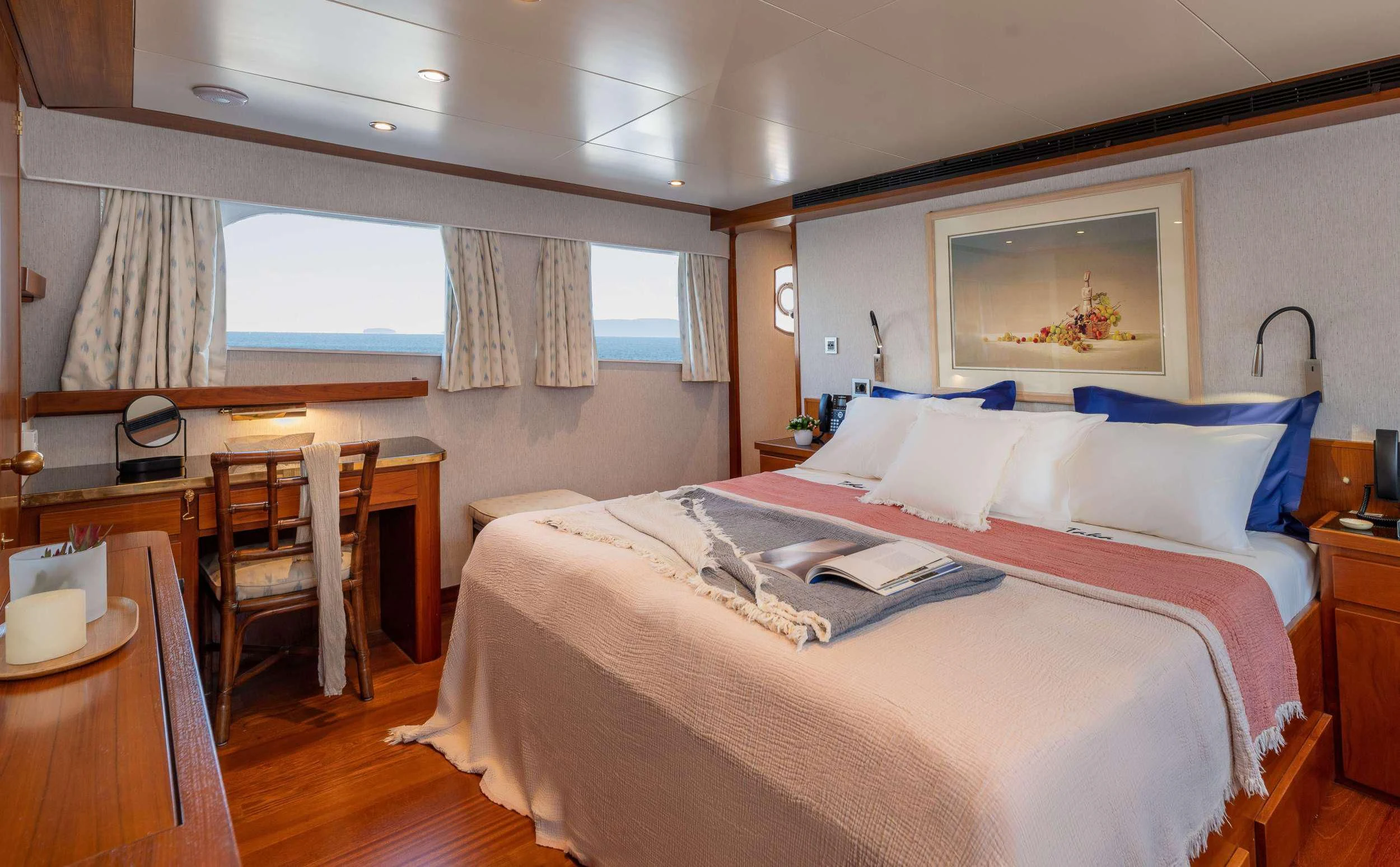 a bed with a white sheet and pillows on it aboard TAKA Yacht for Sale