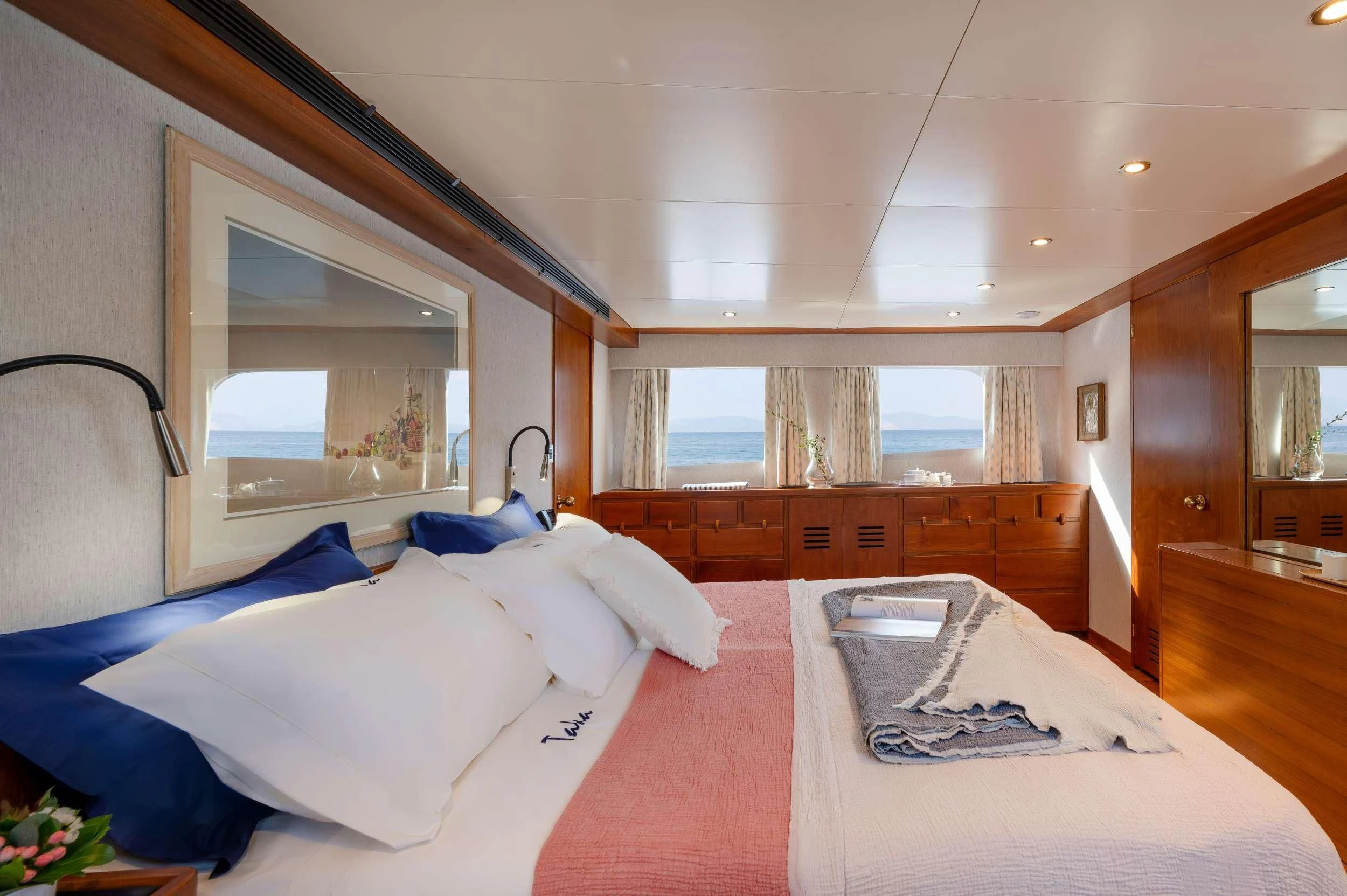 a room with a bed and a mirror aboard TAKA Yacht for Sale