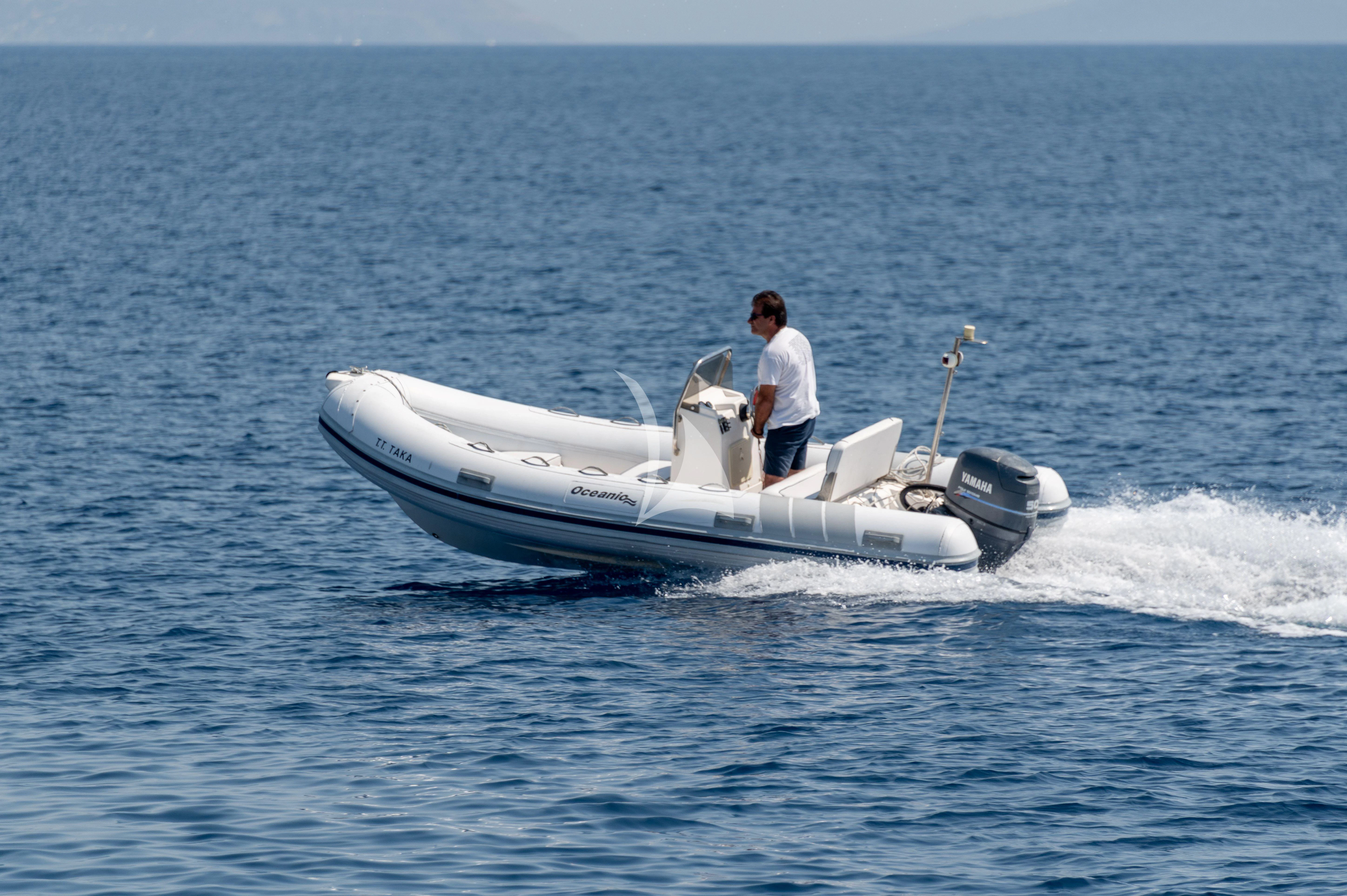 a man driving a boat aboard TAKA Yacht for Sale