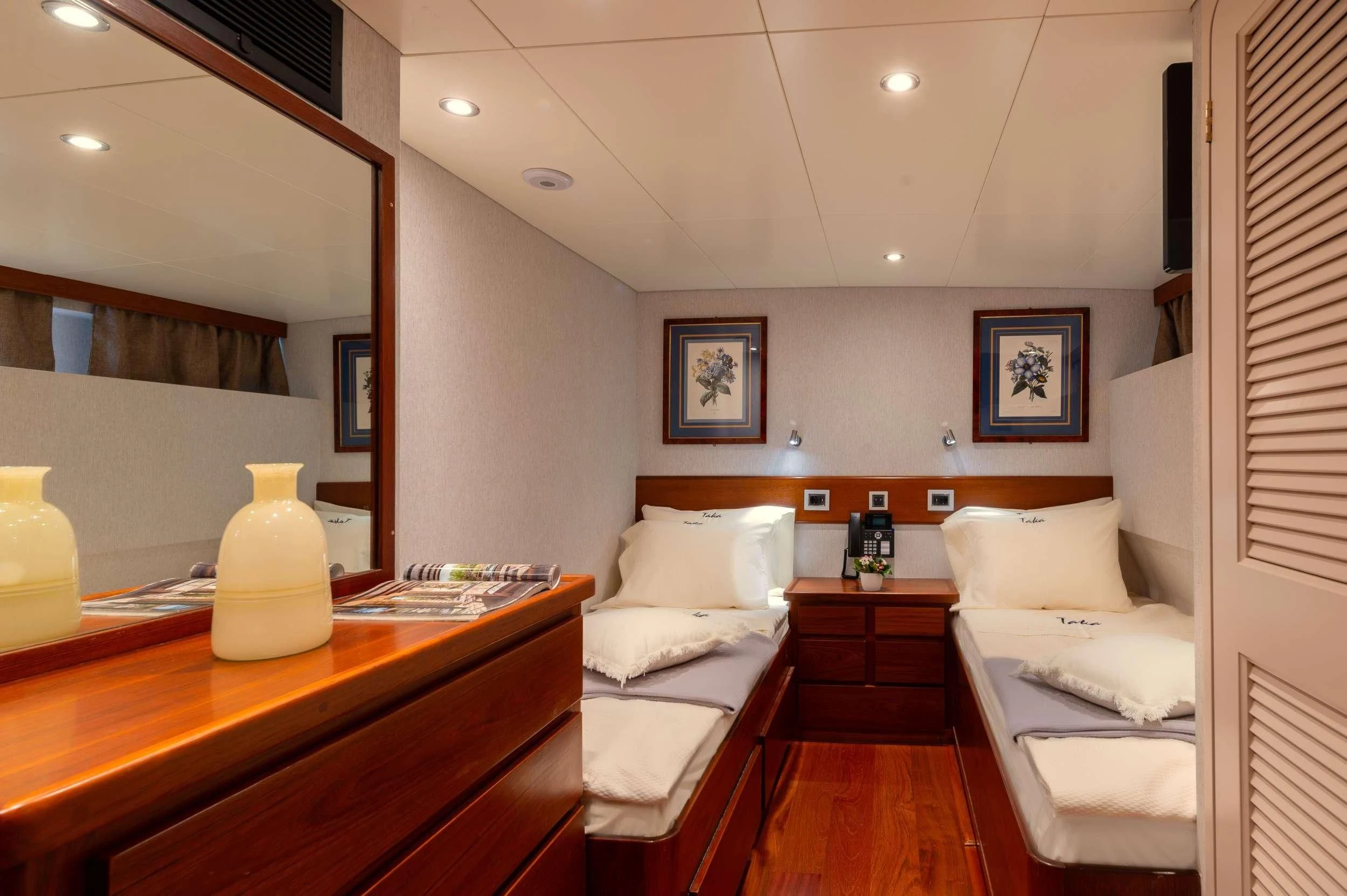 a room with a bed and a table aboard TAKA Yacht for Sale