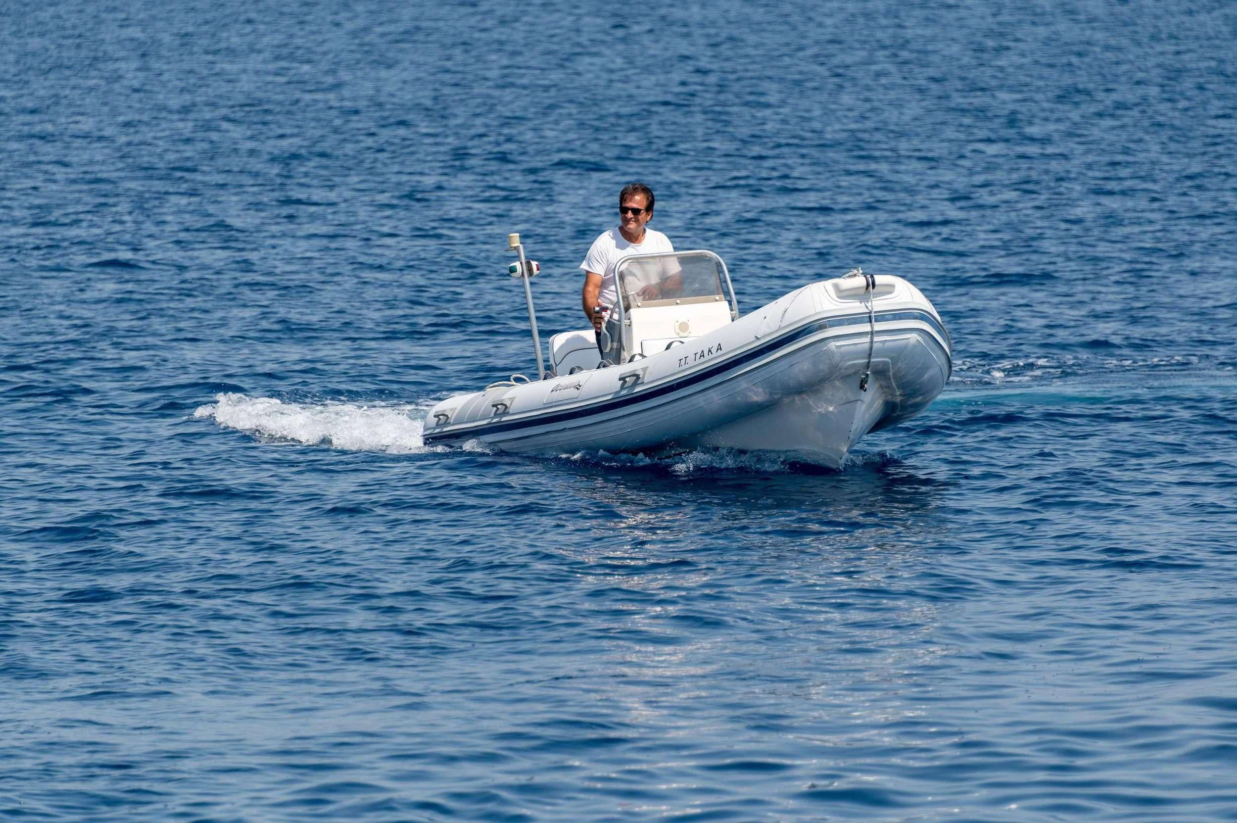 a man in a white boat aboard TAKA Yacht for Sale