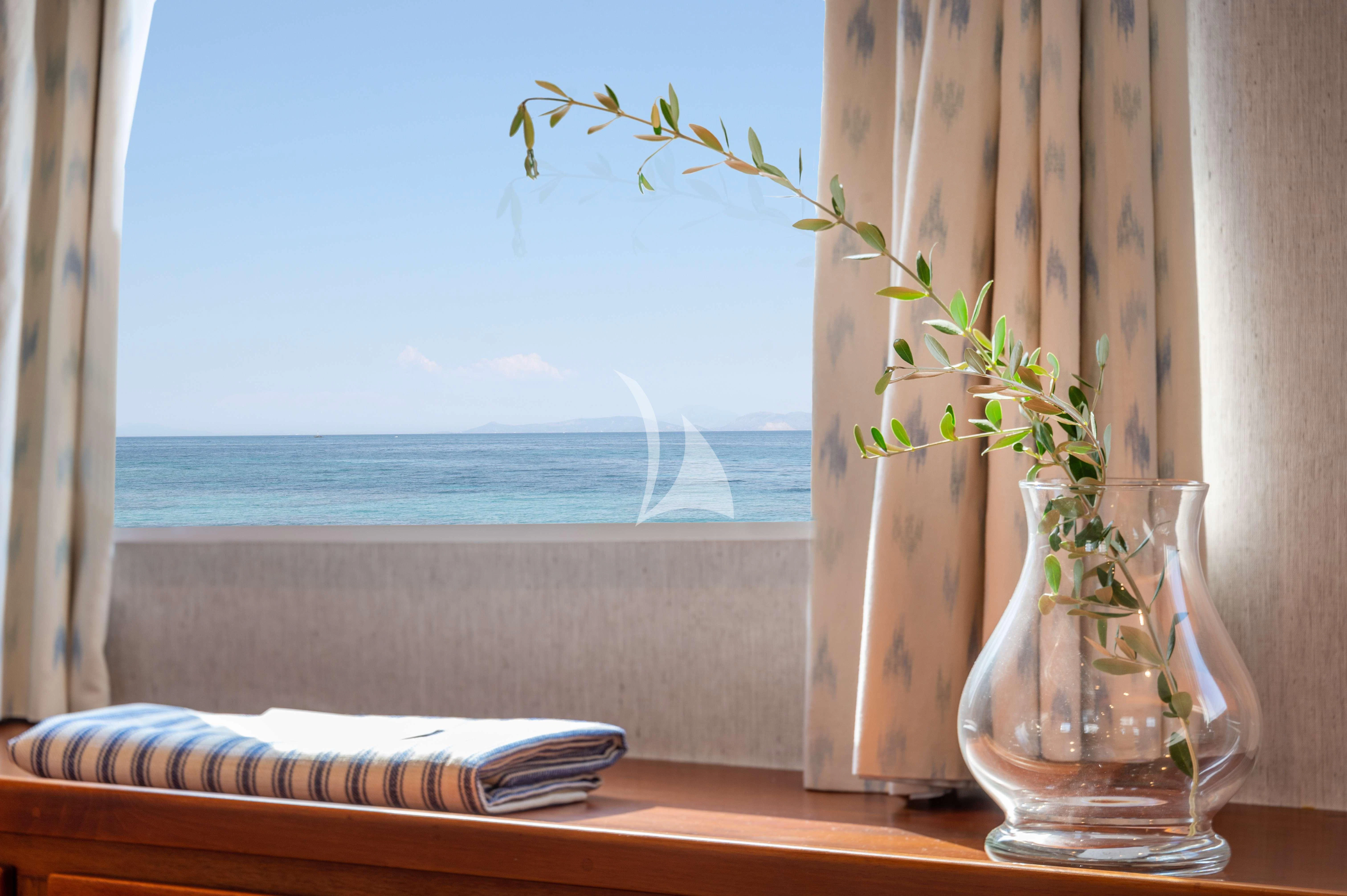 a vase with flowers on a window sill aboard TAKA Yacht for Sale