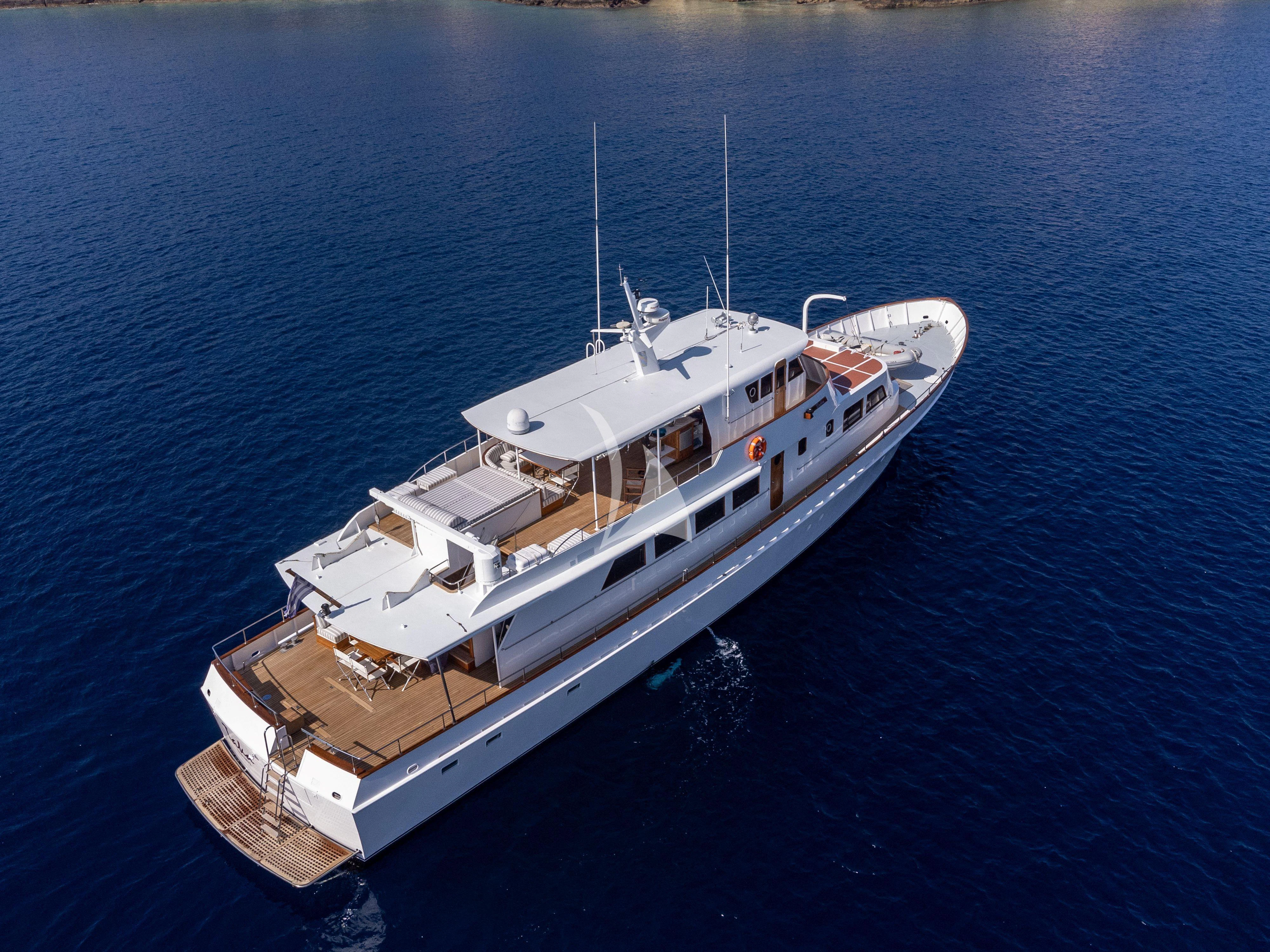 a large white boat in the water aboard TAKA Yacht for Sale