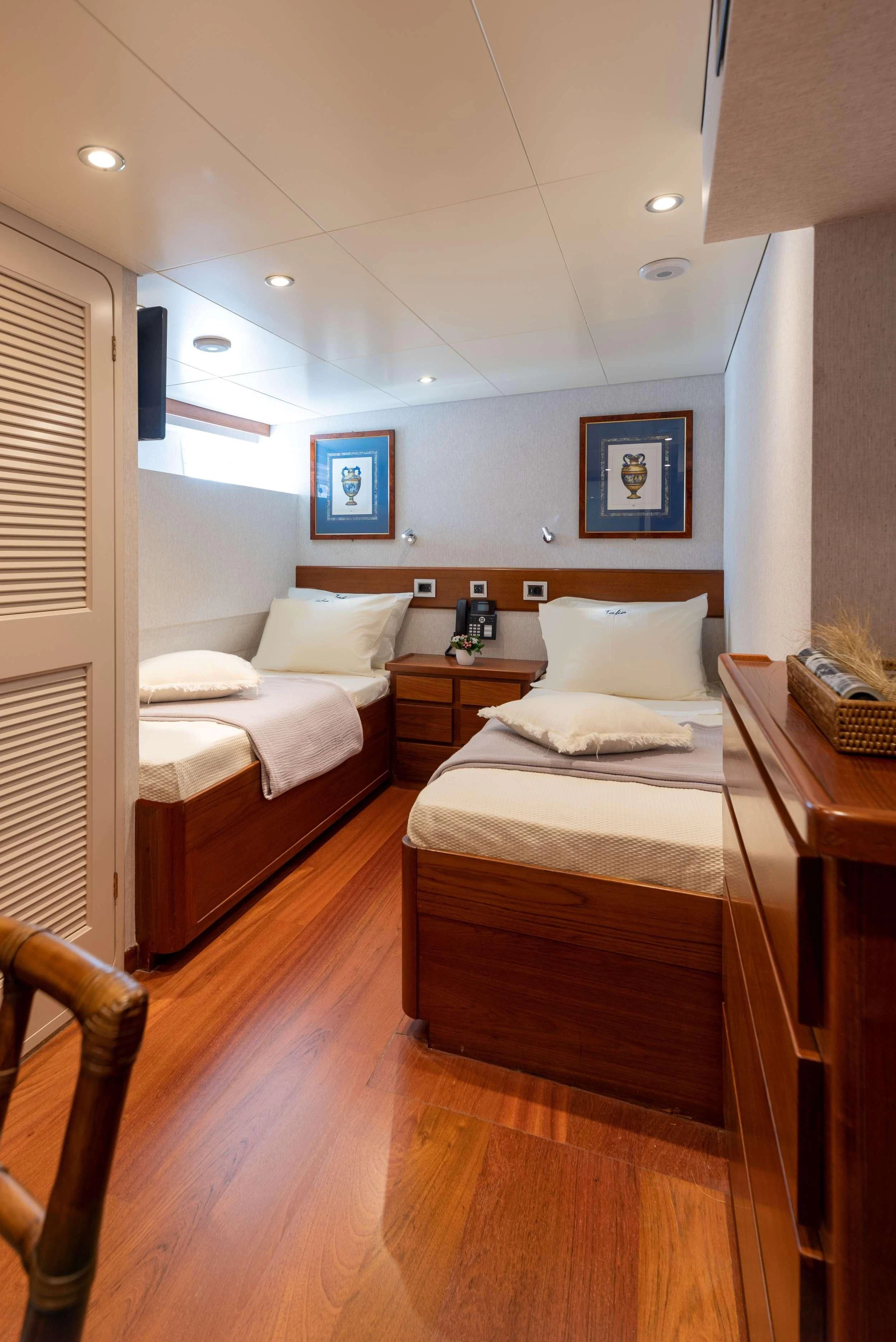 a room with two beds aboard TAKA Yacht for Sale