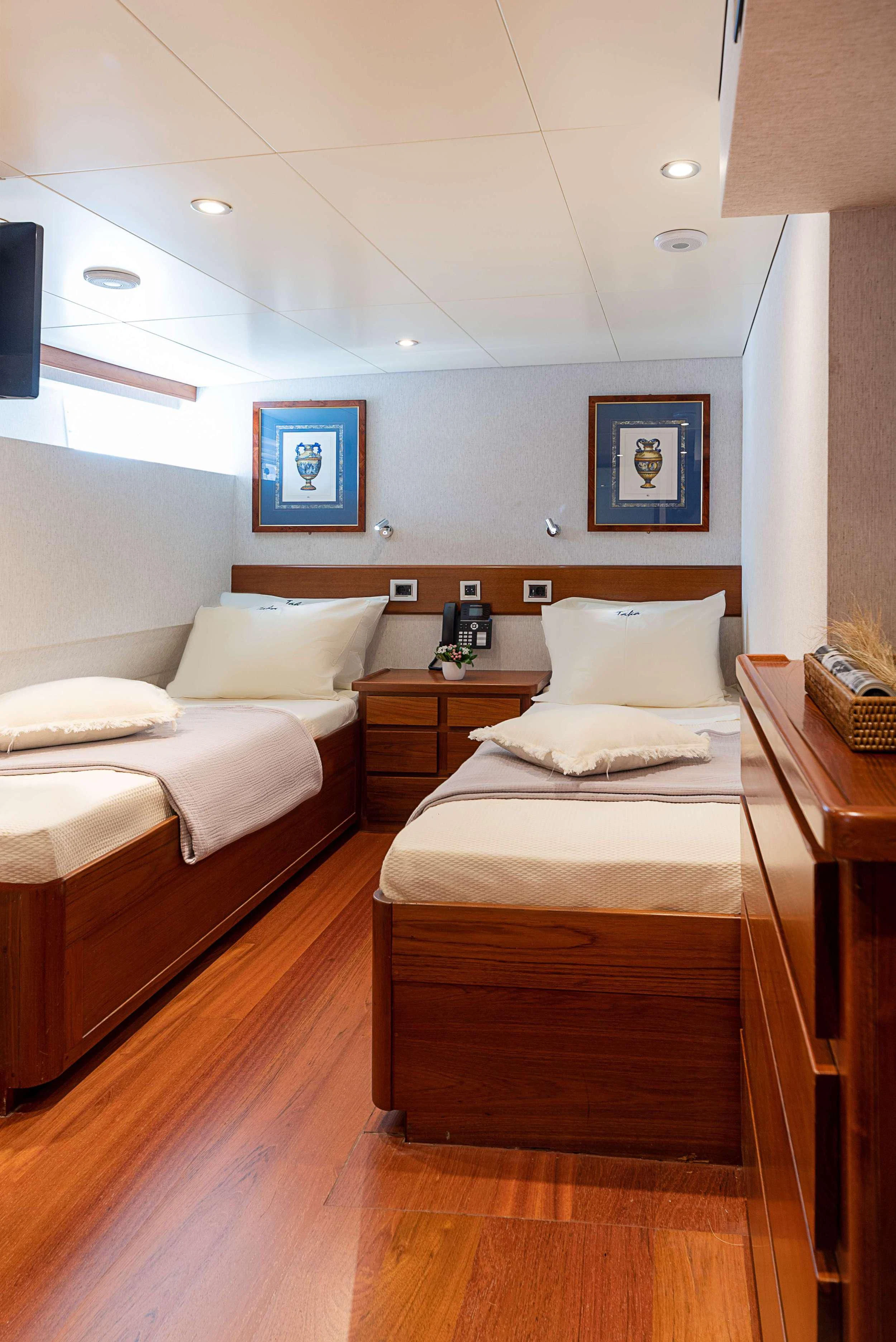 a couple of beds in a room aboard TAKA Yacht for Sale
