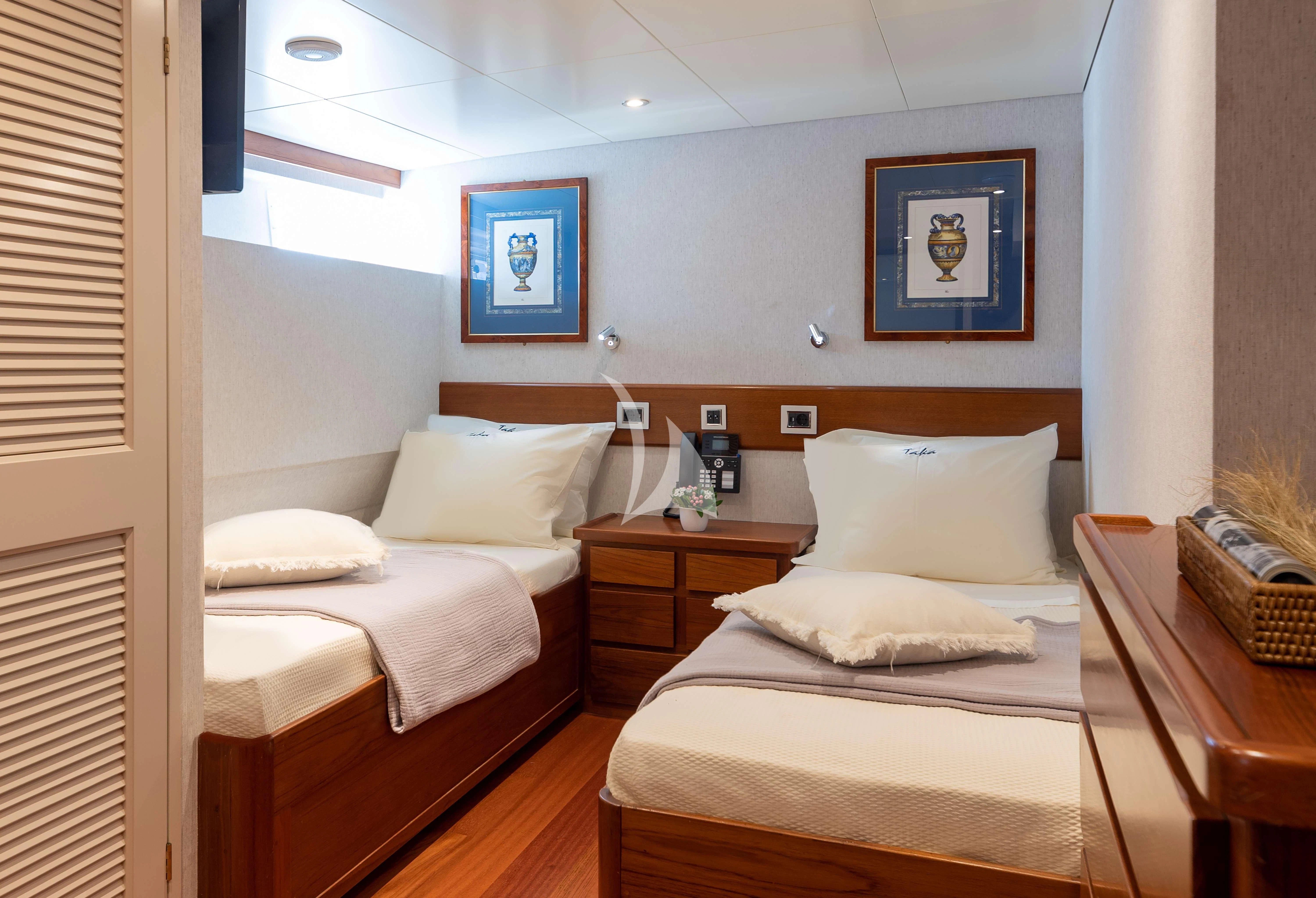 a couple of beds in a hotel room aboard TAKA Yacht for Sale