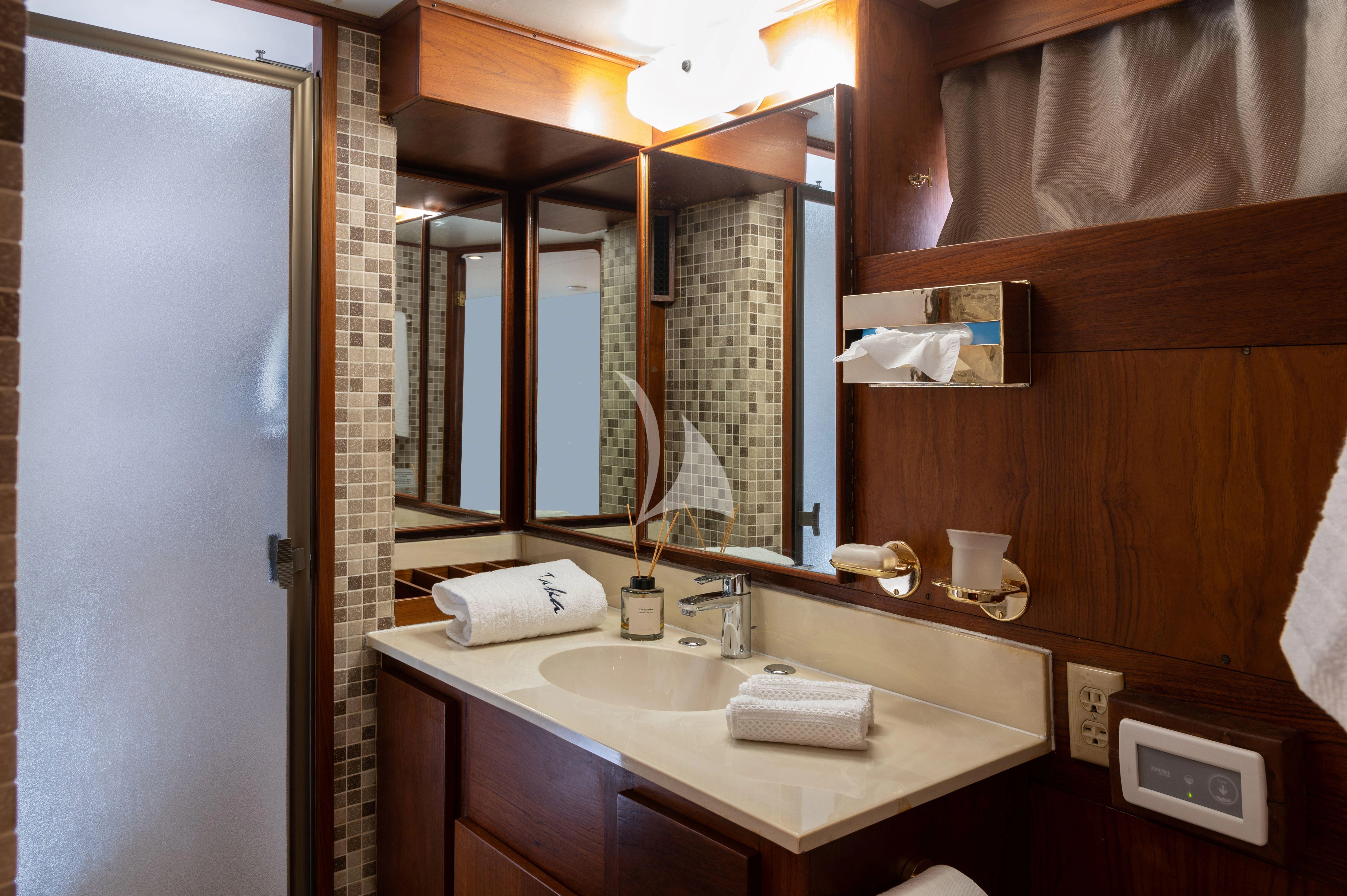 a bathroom with a sink and mirror aboard TAKA Yacht for Sale