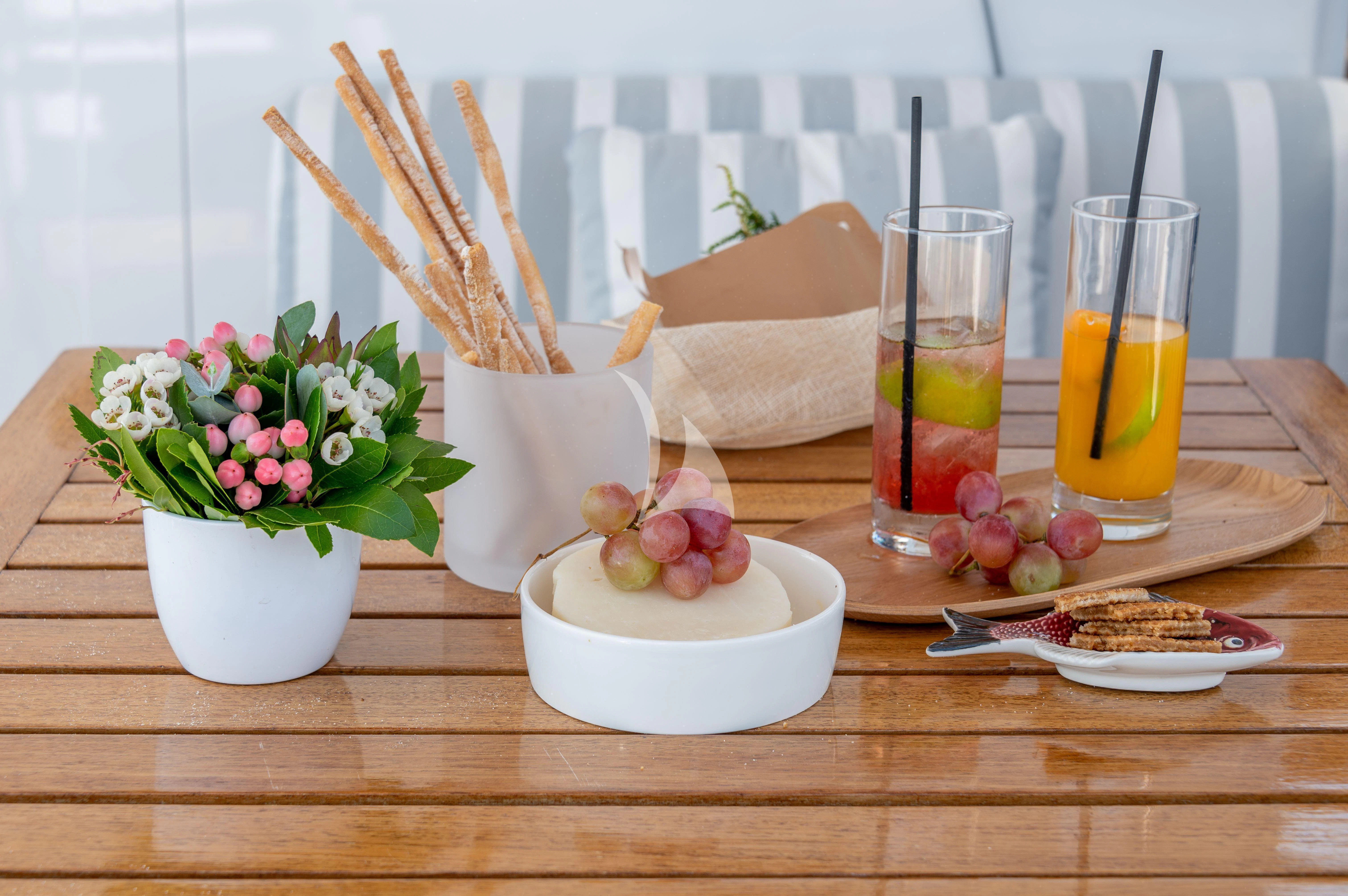 a table with food and drinks aboard TAKA Yacht for Sale