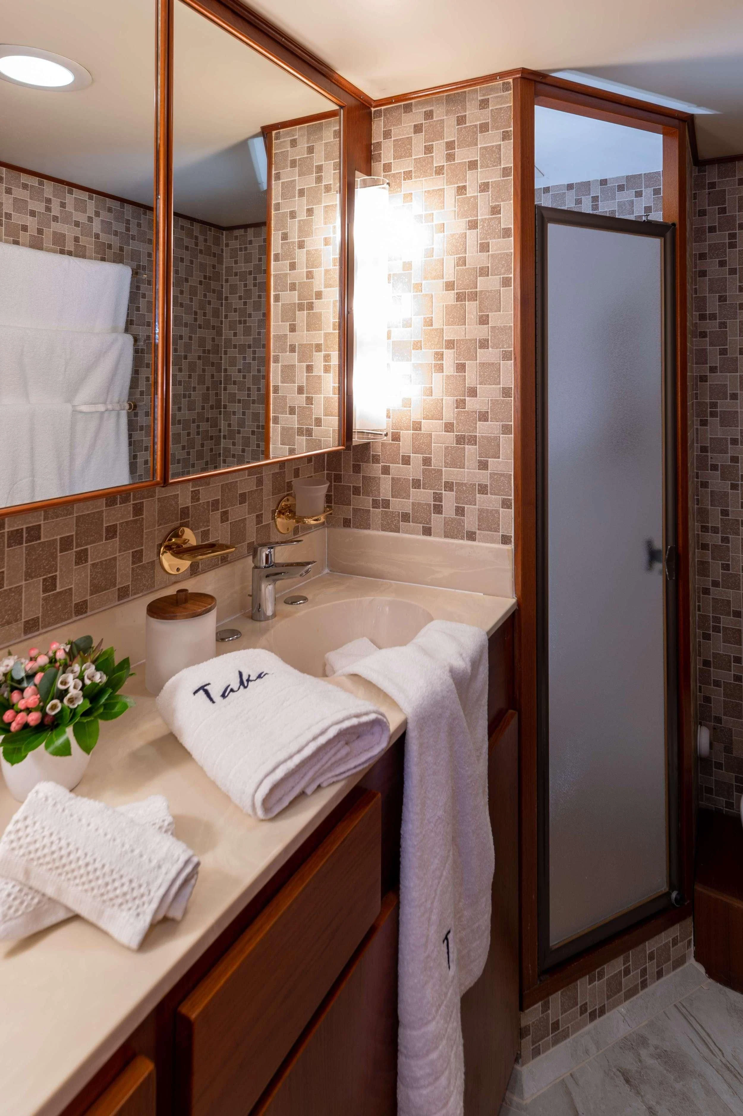 a bathroom with a sink and towels aboard TAKA Yacht for Sale
