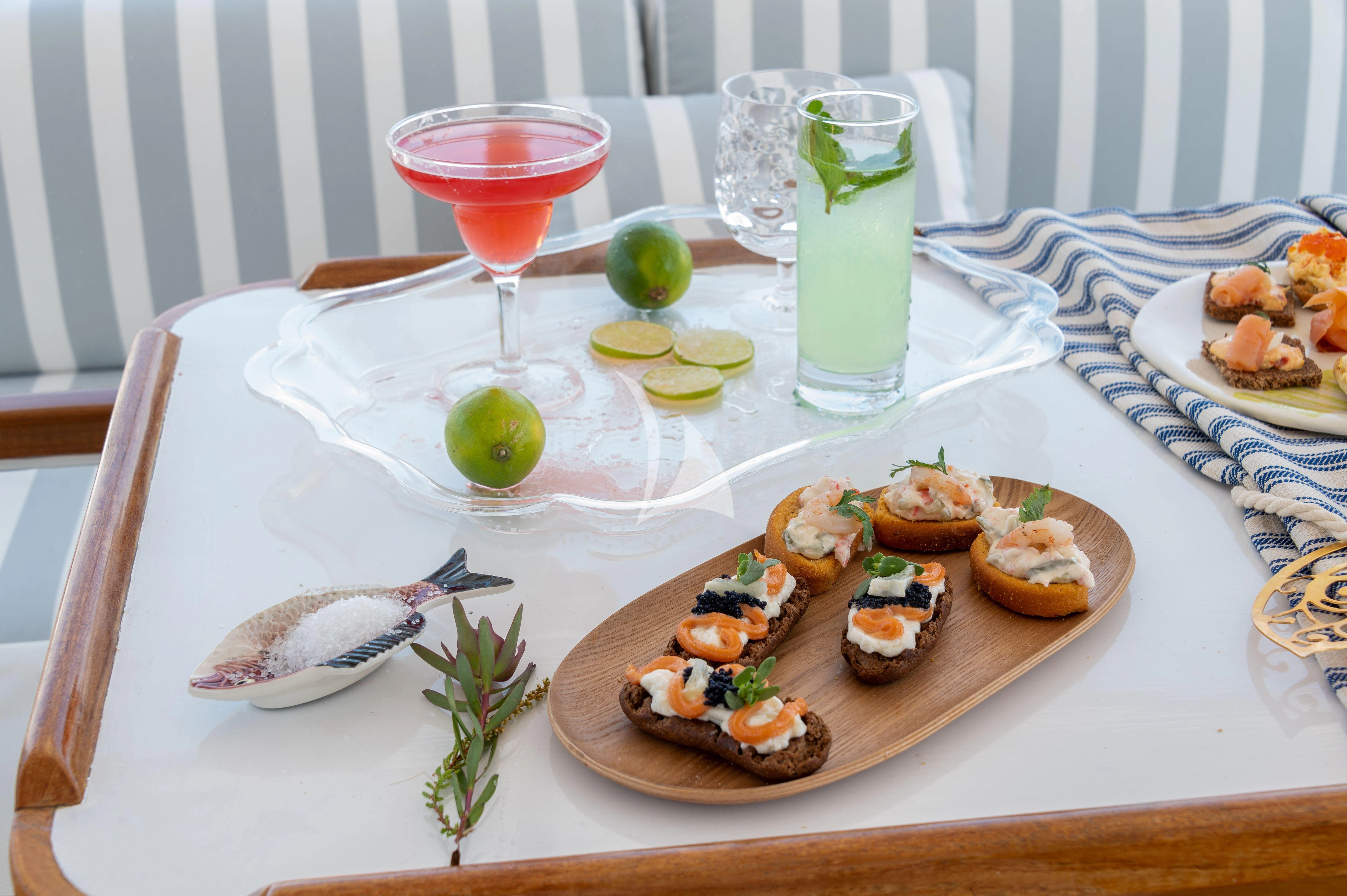 a table with food and drinks on it aboard TAKA Yacht for Sale