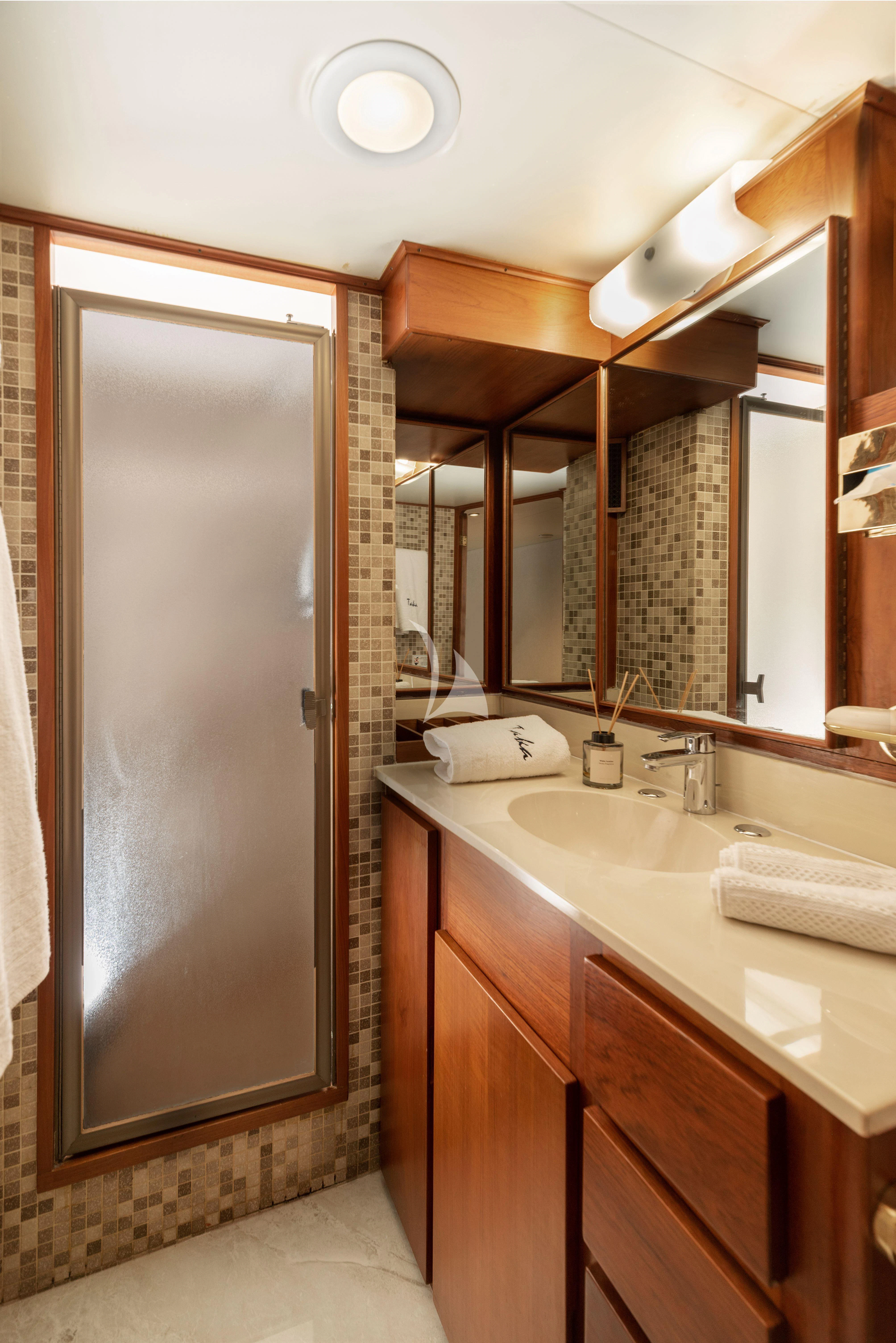 a bathroom with a large mirror aboard TAKA Yacht for Sale