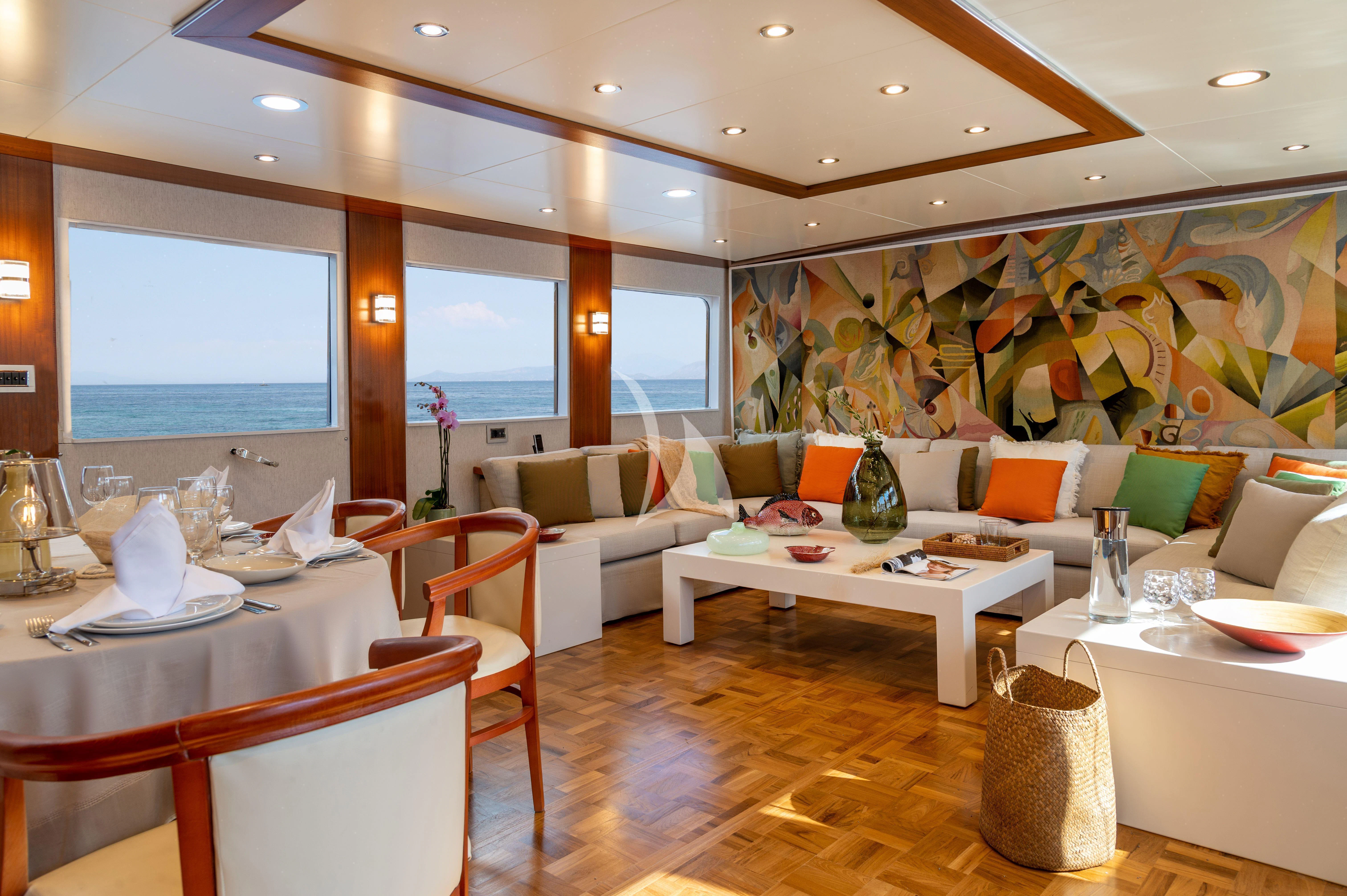 a living room with a large painting aboard TAKA Yacht for Sale