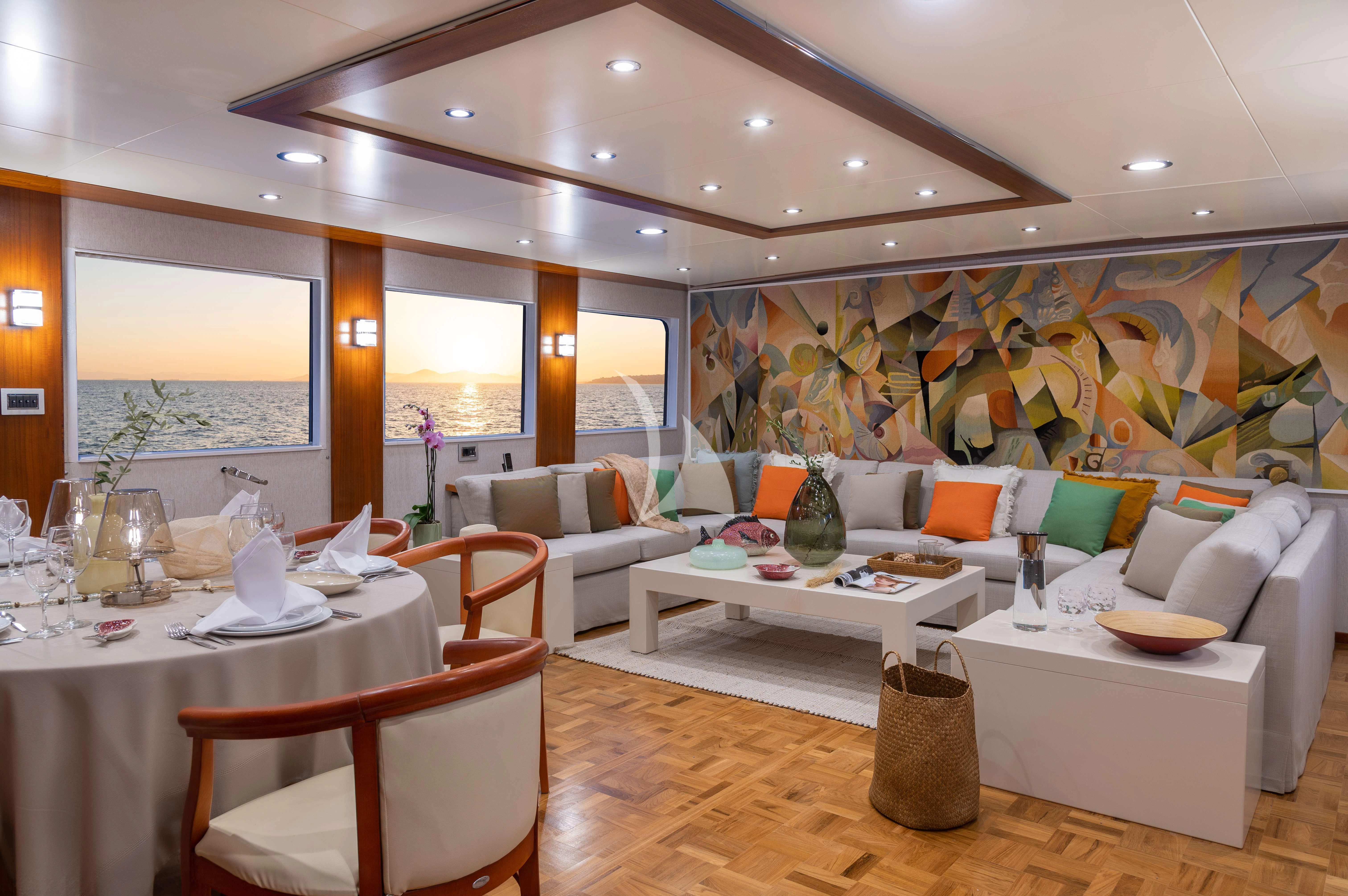 a living room with a large white table and chairs aboard TAKA Yacht for Sale