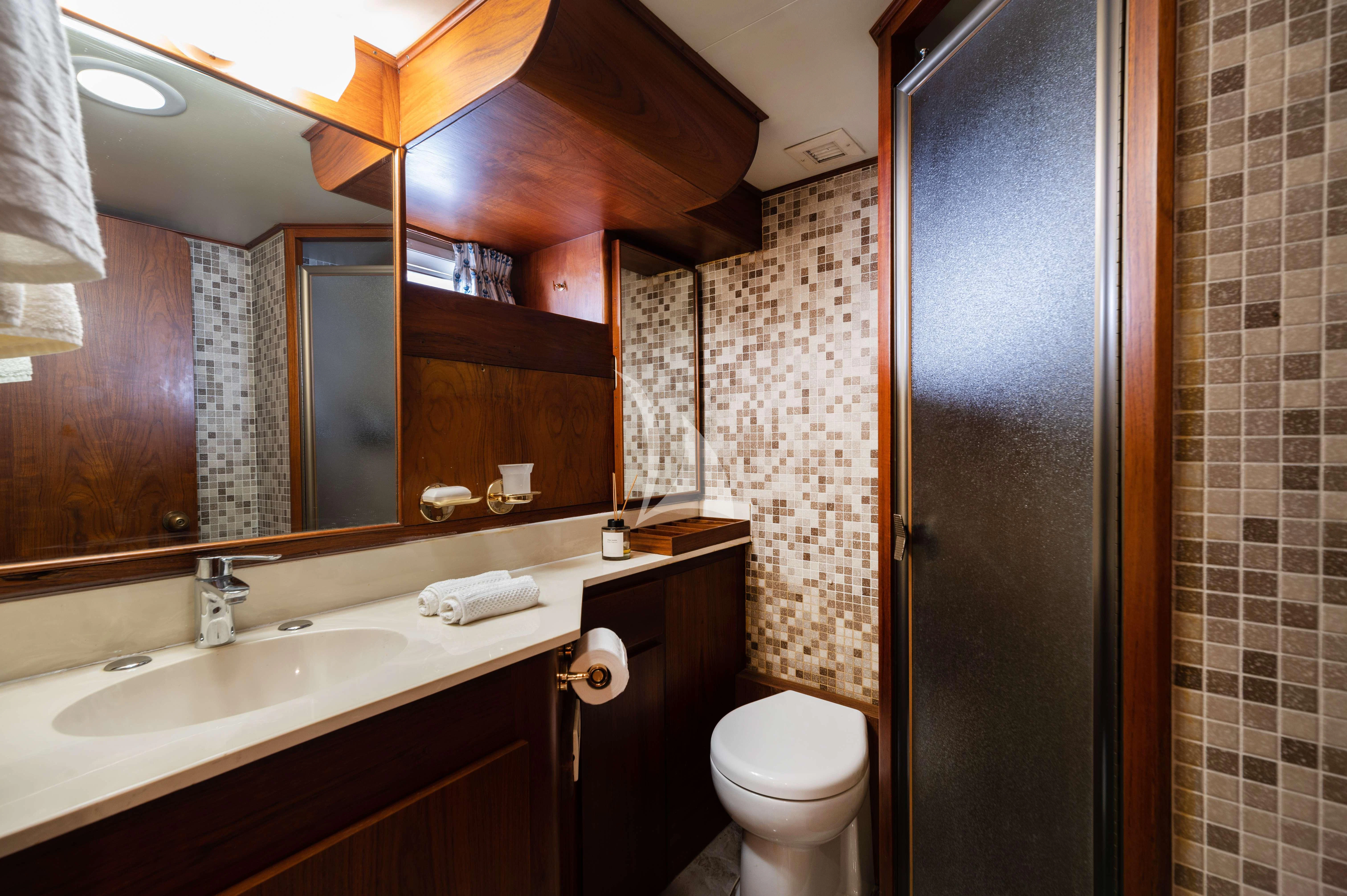a bathroom with a toilet and sink aboard TAKA Yacht for Sale
