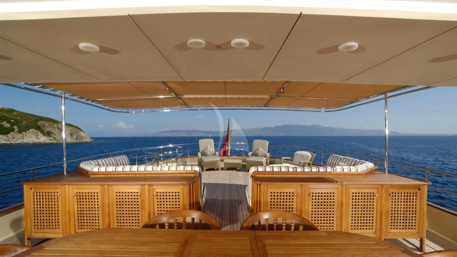 a deck with chairs and a body of water in the background aboard MESERRET Yacht for Sale