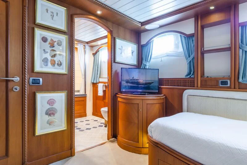 a bedroom with a bed and a television aboard MESERRET Yacht for Sale