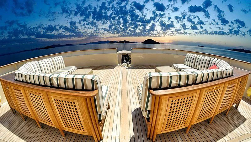 a deck with chairs and a view of the ocean aboard MESERRET Yacht for Sale