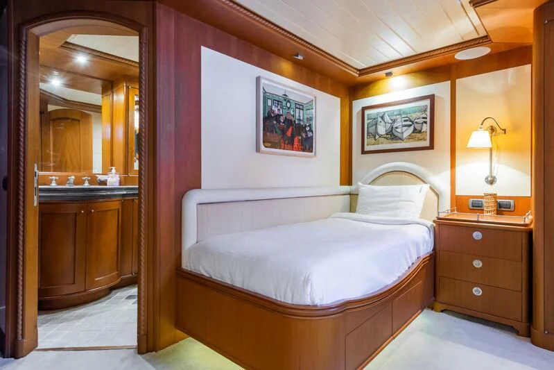 a bedroom with a bed and a mirror aboard MESERRET Yacht for Sale