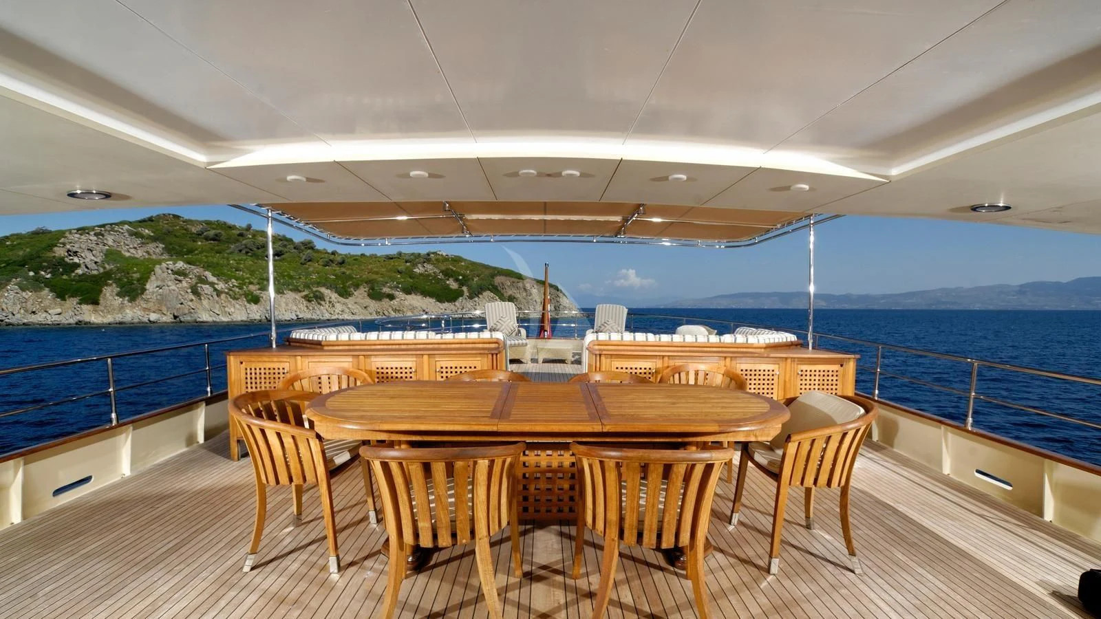 a table and chairs on a deck overlooking a body of water aboard MESERRET Yacht for Sale