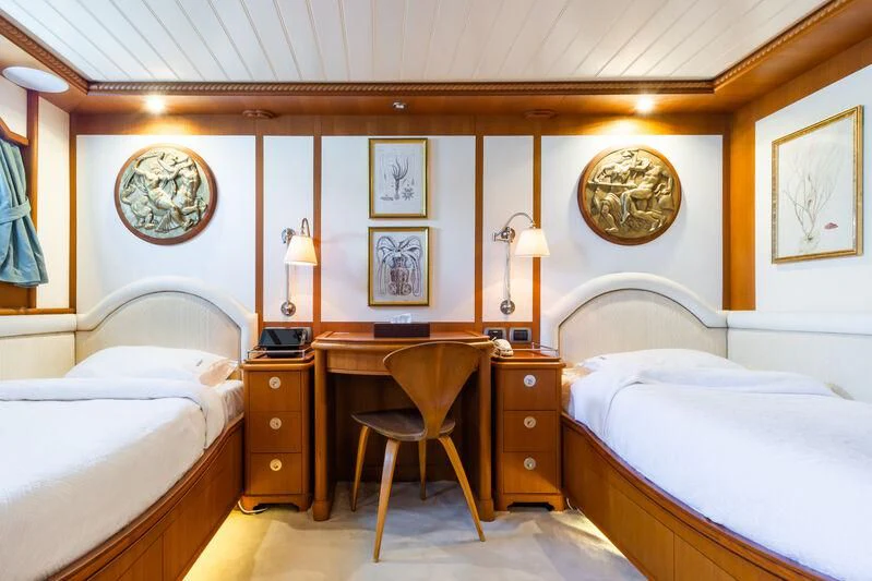 a bedroom with a chair and a bed aboard MESERRET Yacht for Sale
