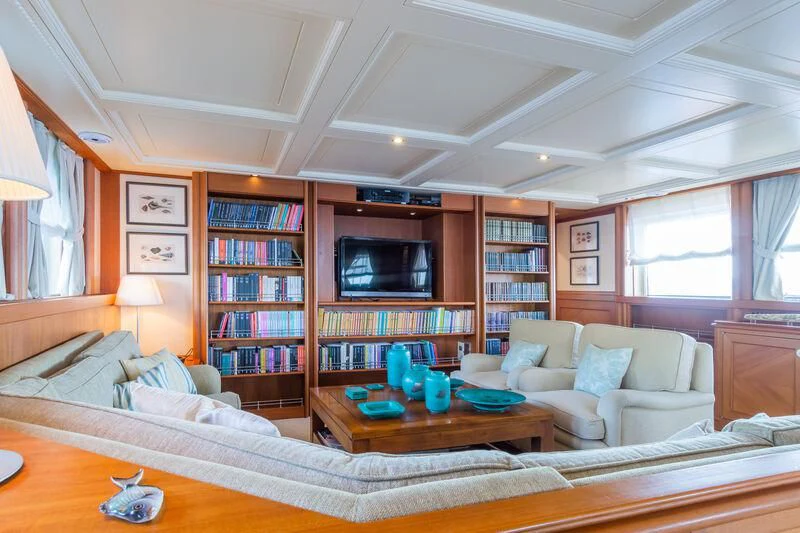 a living room with a large book shelf and a television aboard MESERRET Yacht for Sale