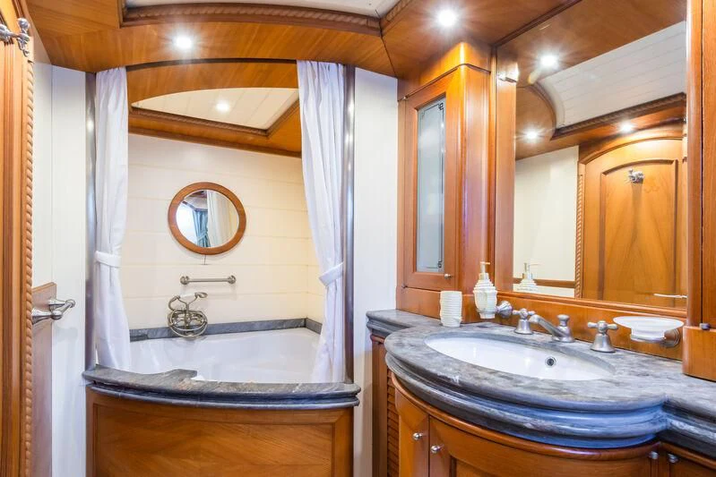 a bathroom with a tub sink and a sink aboard MESERRET Yacht for Sale