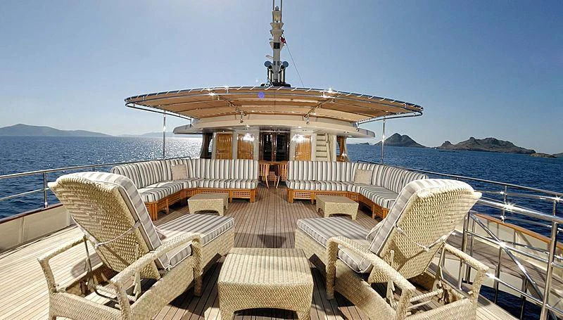 a deck with chairs and a building on it aboard MESERRET Yacht for Sale