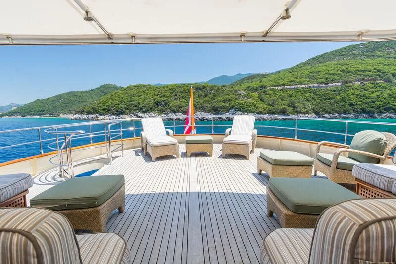 a deck with chairs and a railing overlooking a body of water aboard MESERRET Yacht for Sale