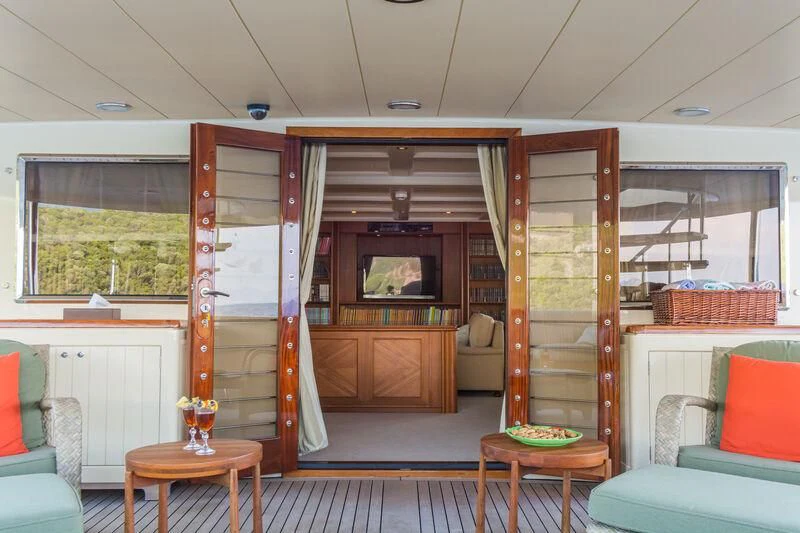 a room with a wood door and a table and chairs aboard MESERRET Yacht for Sale