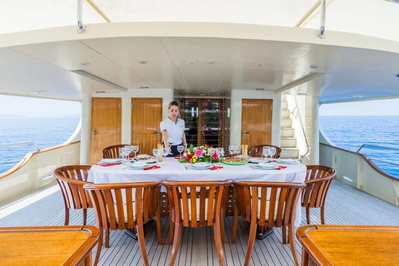 a person standing at a table aboard MESERRET Yacht for Sale