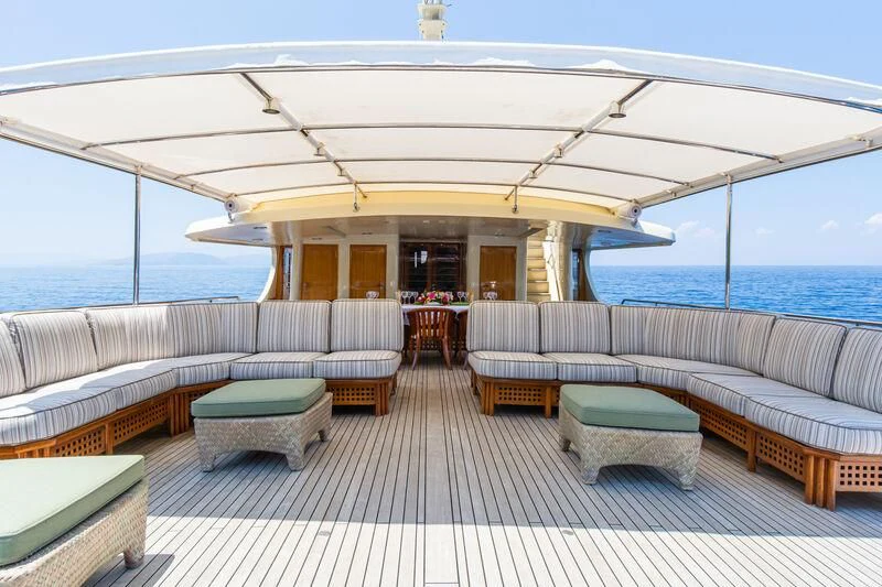 a large lounge area with a large umbrella over it aboard MESERRET Yacht for Sale