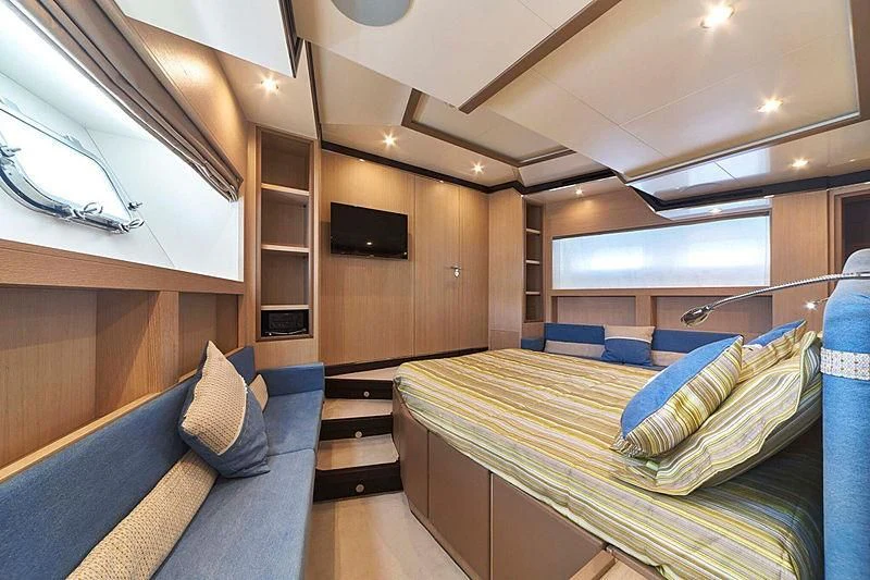 a room with a bed and a tv aboard BLUE BERRY Yacht for Sale