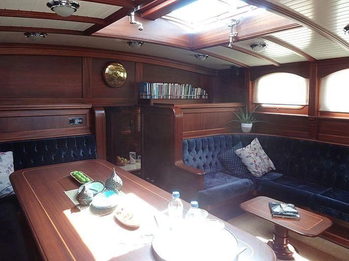 a living room with a couch and a table aboard ILIOS Yacht for Sale