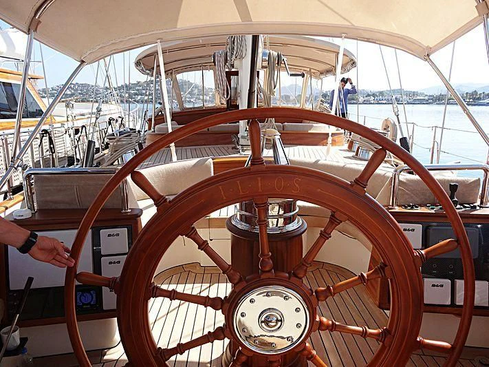a large orange and white boat with a red steering wheel aboard ILIOS Yacht for Sale