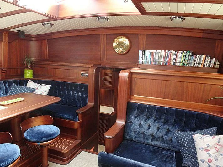 a room with a couch and a table aboard ILIOS Yacht for Sale