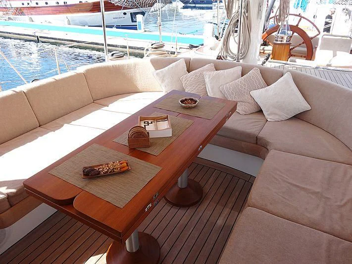 a coffee table on a deck aboard ILIOS Yacht for Sale