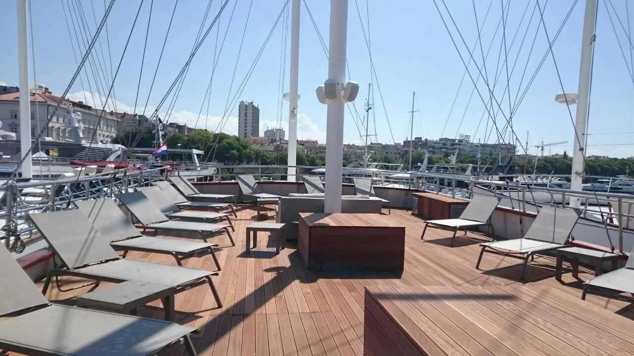 a deck with a view of a city and water aboard ALMISSA Yacht for Sale