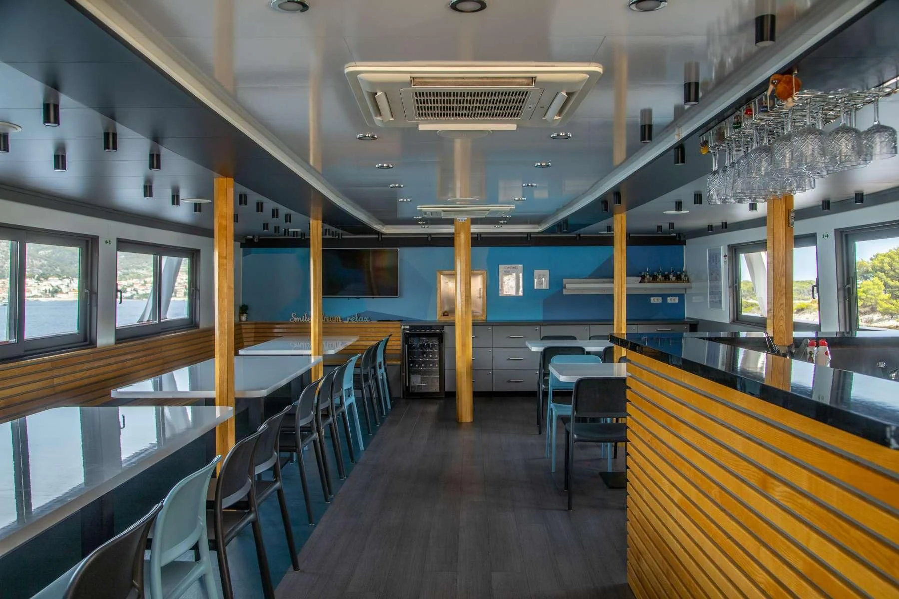 a room with tables and chairs aboard ALMISSA Yacht for Sale
