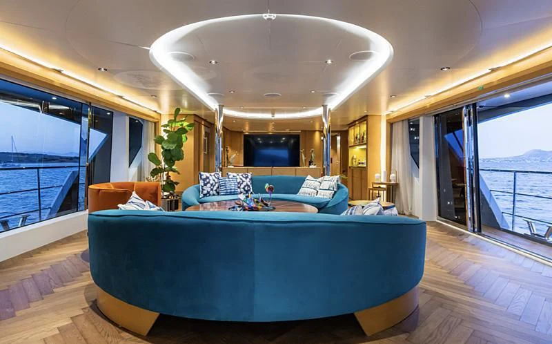 a large living room with a large chandelier aboard LEONIDAS Yacht for Sale