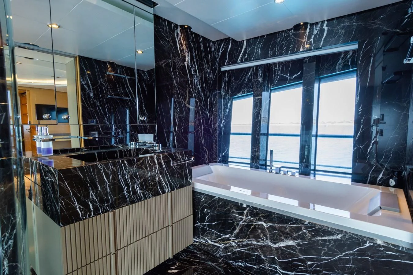 a bathroom with a tub and shower aboard LEONIDAS Yacht for Sale