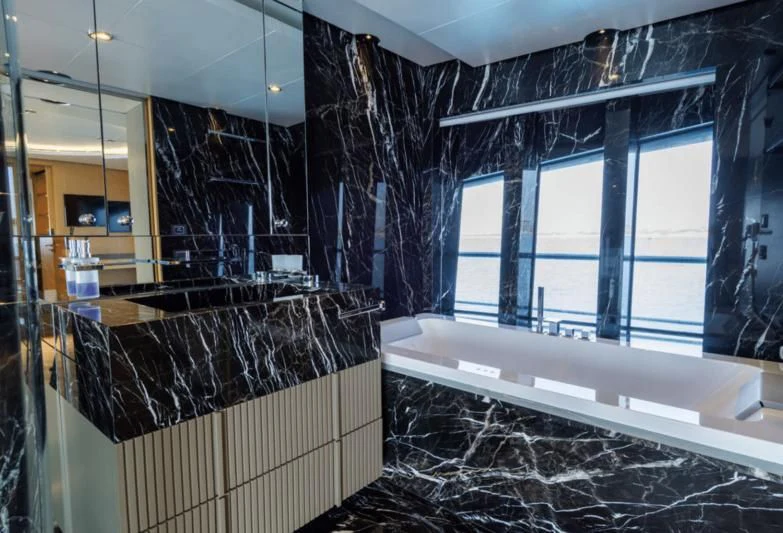 a bathroom with a tub and shower aboard LEONIDAS Yacht for Sale