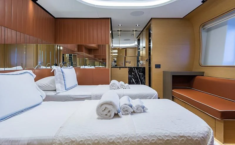 a room with a bed and a bench aboard LEONIDAS Yacht for Sale