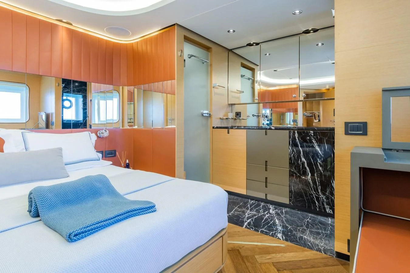 a room with a bed and a mirror aboard LEONIDAS Yacht for Sale