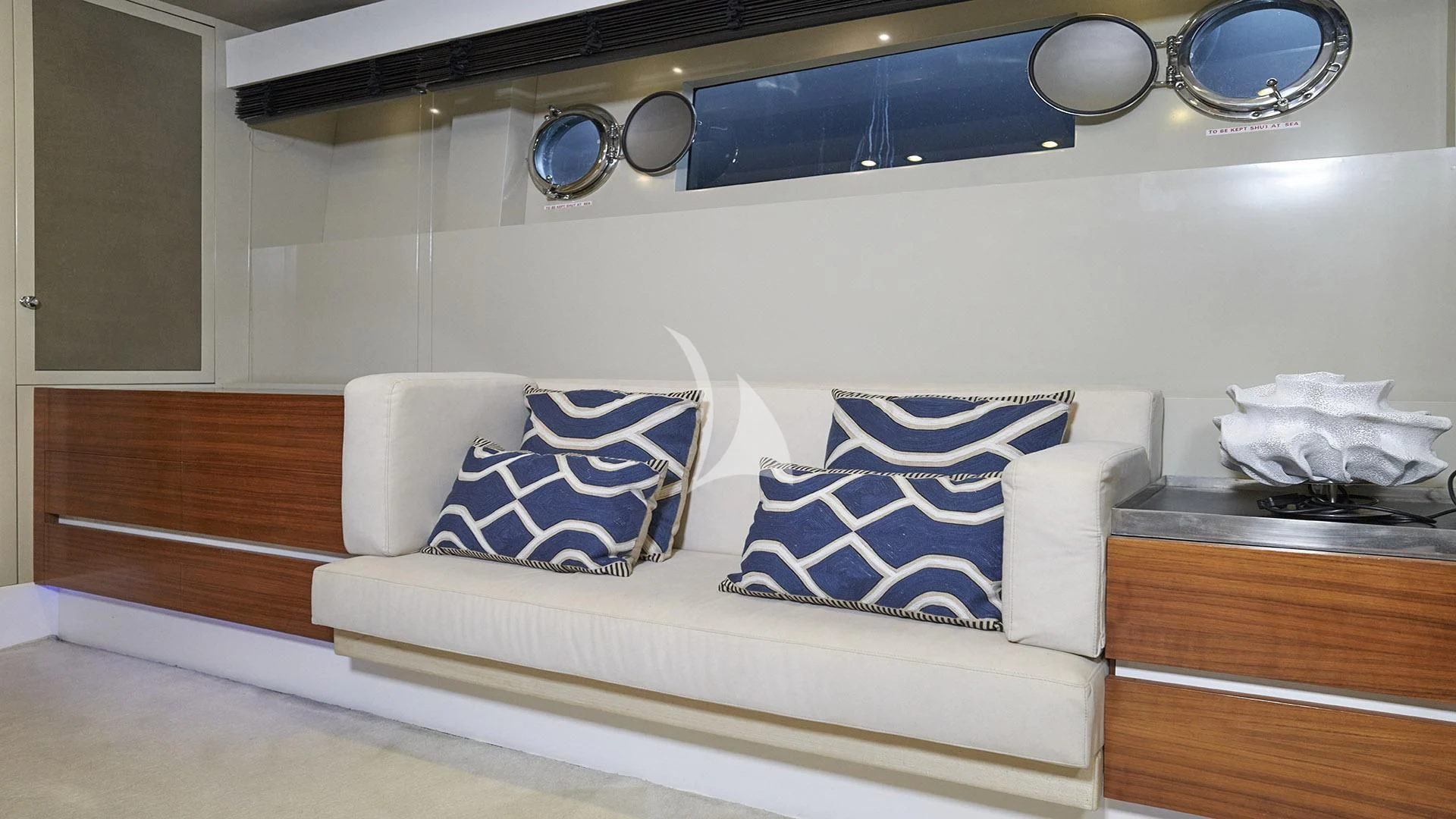 a white couch with blue pillows aboard FUNKY TOWN Yacht for Sale