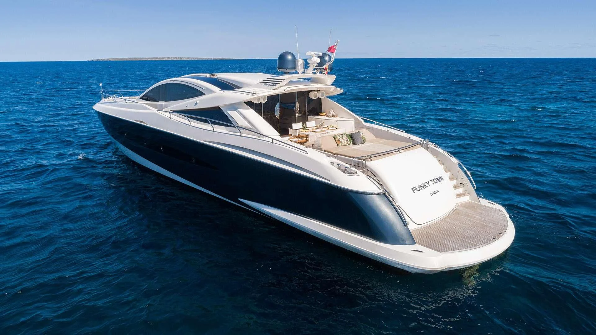 a white boat in the water aboard FUNKY TOWN Yacht for Sale