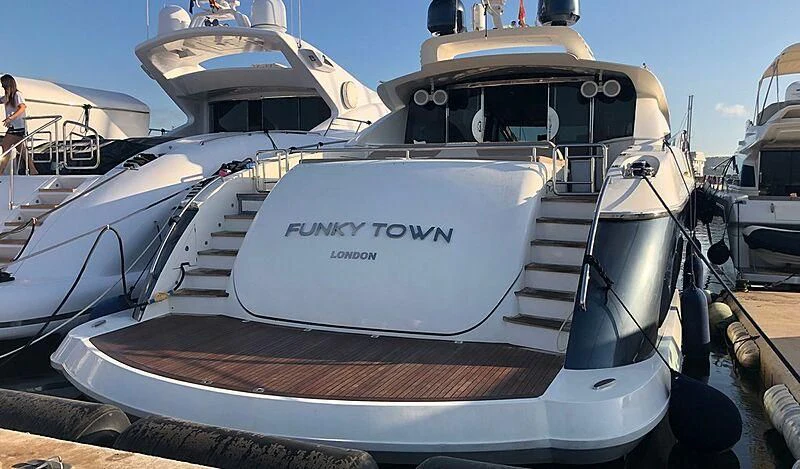 a boat docked at a pier aboard FUNKY TOWN Yacht for Sale